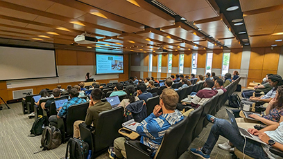 Students sit in a lecture hall for a presentation during the 2023 FRIB Theory Alliance Summer School.