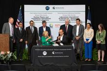 A photo of the contract signing to establish the International Research Laboratory on Nuclear Physics and Astrophysics (IRL NPA) at the Facility for Rare Isotope Beams (FRIB) at MSU.