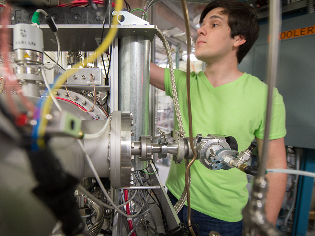 Man with green shirt working on machine
