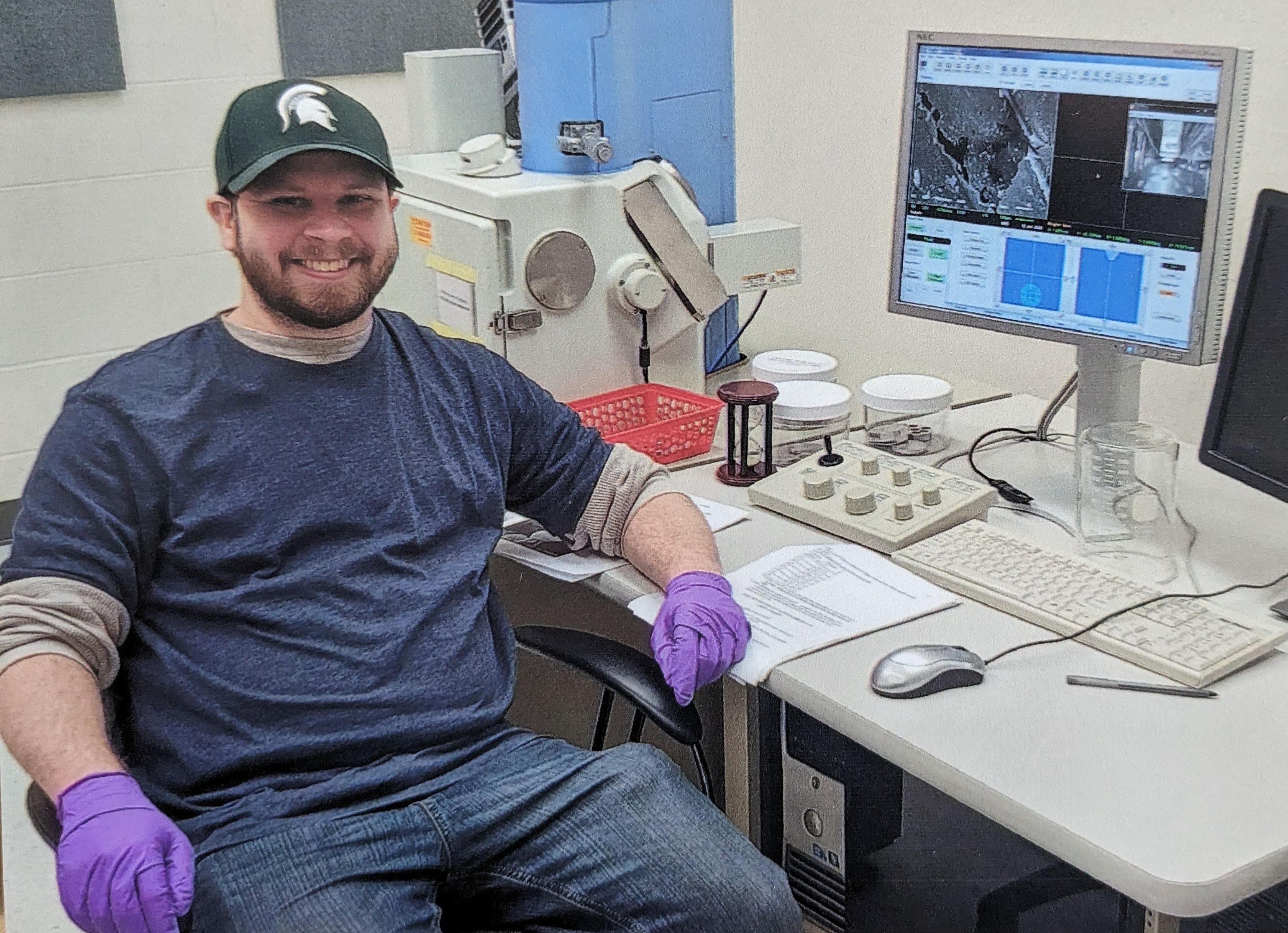 A photo of Ethan Fletcher, graduate student, sitting at a desk.