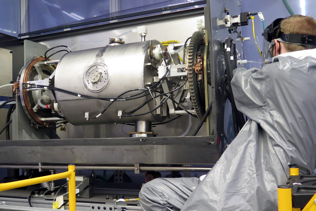 A man working on a superconducting radio-frequency cavity