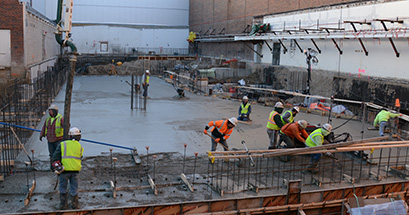 Workers place concrete for the High Rigidity Spectrometer and Isotope Harvesting Vault foundation slab. The addition is scheduled to be completed in November 2019.
