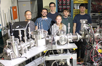 Pictured, from left: Kei Minamisono, senior scientist at FRIB; Skyy Pineda, graduate student at FRIB; Shane Wilkins, postdoctoral associate at MIT; Brooke Rickey, graduate student at FRIB; Adam Vernon, postdoctoral associate at MIT; Alex Brinson, graduate student at MIT. They stand behind the laser spectroscopy system called Resonant ionization Spectroscopy Experiments (RiSE).