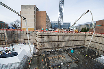 Workers place concrete for the floor of the target area on December 1.