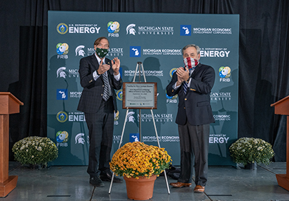 U.S. Secretary of Energy Dan Brouillette (right) designated the Facility for Rare Isotope Beams as a U.S. Department of Energy Office of Science user facility 29 September. Pictured above is Brouillette with MSU President Samuel L. Stanley Jr., M.D. (left) as they unveil the designation plaque.