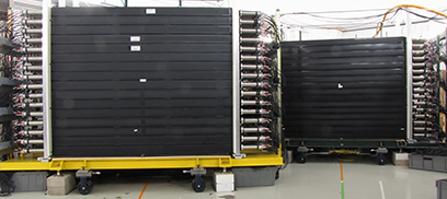 A photo of the MoNA-LISA neutron detector array, which is made of long scintillator bars that are read out by a pair of photosensors (photo multiplier tubes) at each end. 