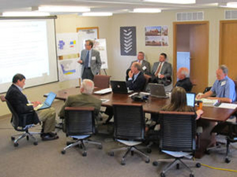 Peer review committee members and the FRIB Conventional Facilities team examine the preliminary design of FRIB conventional facilities at MSU.