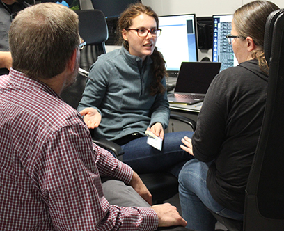 Scientists arrive at the Facility for Rare Isotope Beams (FRIB) to run the first FRIB scientific user experiment using the FRIB Decay Station Initiator. Above, Sean Liddick (FRIB, left) discusses the experiment with contact spokesperson Heather Crawford (Lawrence Berkeley National Laboratory (LBNL), right) and Carlotta Porzio (LBNL, center).  (Photo credit: Facility for Rare Isotope Beams)