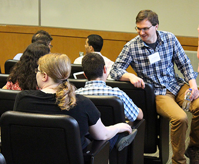 Lecturer Luke Roberts (right) talks to attendees of the summer school.