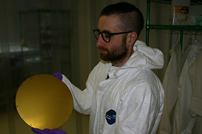 Yassid Ayyad, detector systems physicist at the National Superconducting Cyclotron Laboratory at Michigan State University, is part of the research team that observed a rare decay in the exotic beryllium-11 nucleus. Here he holds the pad plane of the Active Target Time Projection Chamber detector that was used in the experiment. Credit: National Superconducting Cyclotron Laboratory