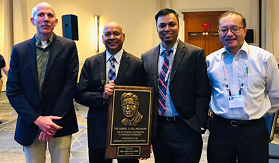 MSU Cryogenics Initiative Director Venkatarao Ganni (second from left) receives the 2019 Samuel C. Collins Award. Pictured from left: Senior Cryogenic Process Engineer Peter Knudsen, Ganni, Cryogenic Process Engineer Nusair Hasan, and FRIB Accelerator Systems Division Director Jie Wei.