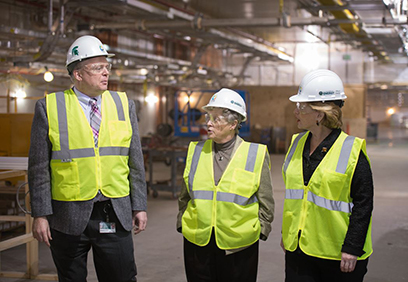 FRIB Project Director Thomas Glasmacher (left) talks with MSU President Lou Anna K. Simon and Senator Debbie Stabenow (right) during a tour of the FRIB construction site on 22 December. Photo by Greg Kohuth, MSU Communications and Brand Strategy 