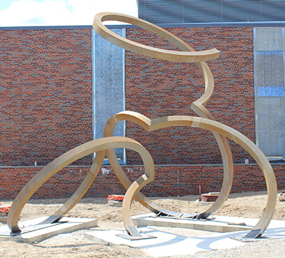 FRIB site-restoration work is complete and both MSU-funded building additions will be complete this month. Above is one of the three on-site sculptures created by artist Dee Briggs. The sculptures were installed on the FRIB site in August.