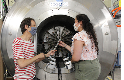 Professor Daniel Bazin (left) works with a graduate student on the SOLenoid spectrometer Apparatus for ReactIon Studies (SOLARIS).