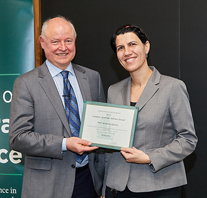 MSU College of Natural Science Dean Phil Duxbury (left) presents Associate Professor of Physics and NSCL Associate Director for Education and Outreach Artemis Spyrou (right) with the 2018 Graduate Academic Advisor Award. (Photo credit: College of Natural Science/David-Lorne Photographic)