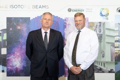 Ambassador of France to the United States Laurent Bili (left) and Michigan State University (MSU) Interim Provost Thomas Jeitschko (right) stand next to one another in front of a mural at the Facility for Rare Isotope Beams.