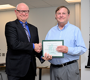 MSU College of Natural Science Dean Phil Duxbury (left) presents Alex Brown, professor of physics at FRIB and in the MSU Department of Physics and Astronomy, (right) with his 2022 Research Leadership Award.