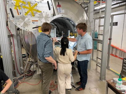 A group of scientists in front of the SOLenoid Spectrometer Apparatus for ReactIon Studies (SOLARIS).