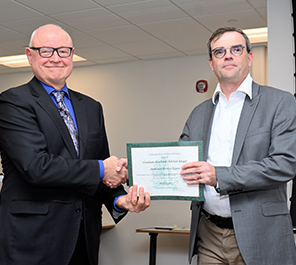 MSU College of Natural Science Dean Phil Duxbury (left) presents Remco Zegers, professor of physics at FRIB and in the MSU Department of Physics and Astronomy, (right) with his 2022 Graduate Academic Advisor Award.