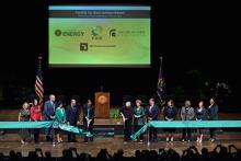 U.S. Secretary of Energy Jennifer M. Granholm (center right) and MSU President Samuel L. Stanley Jr., M.D. (center left) cut the ribbon to officially mark the start of FRIB’s scientific mission. 